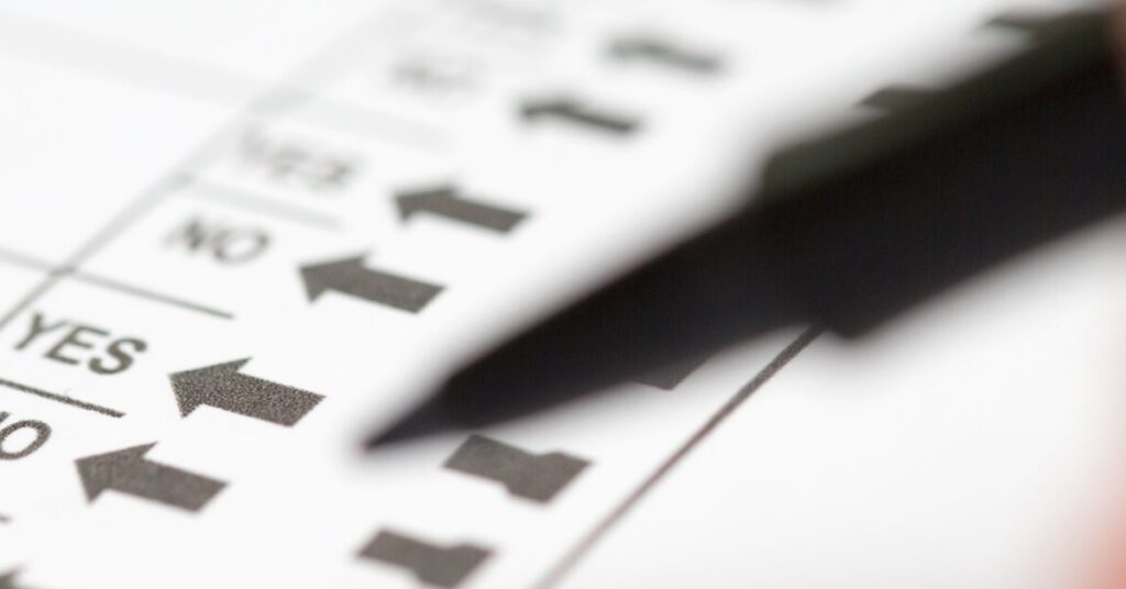 Voter preparing to make selections on ballot propositions